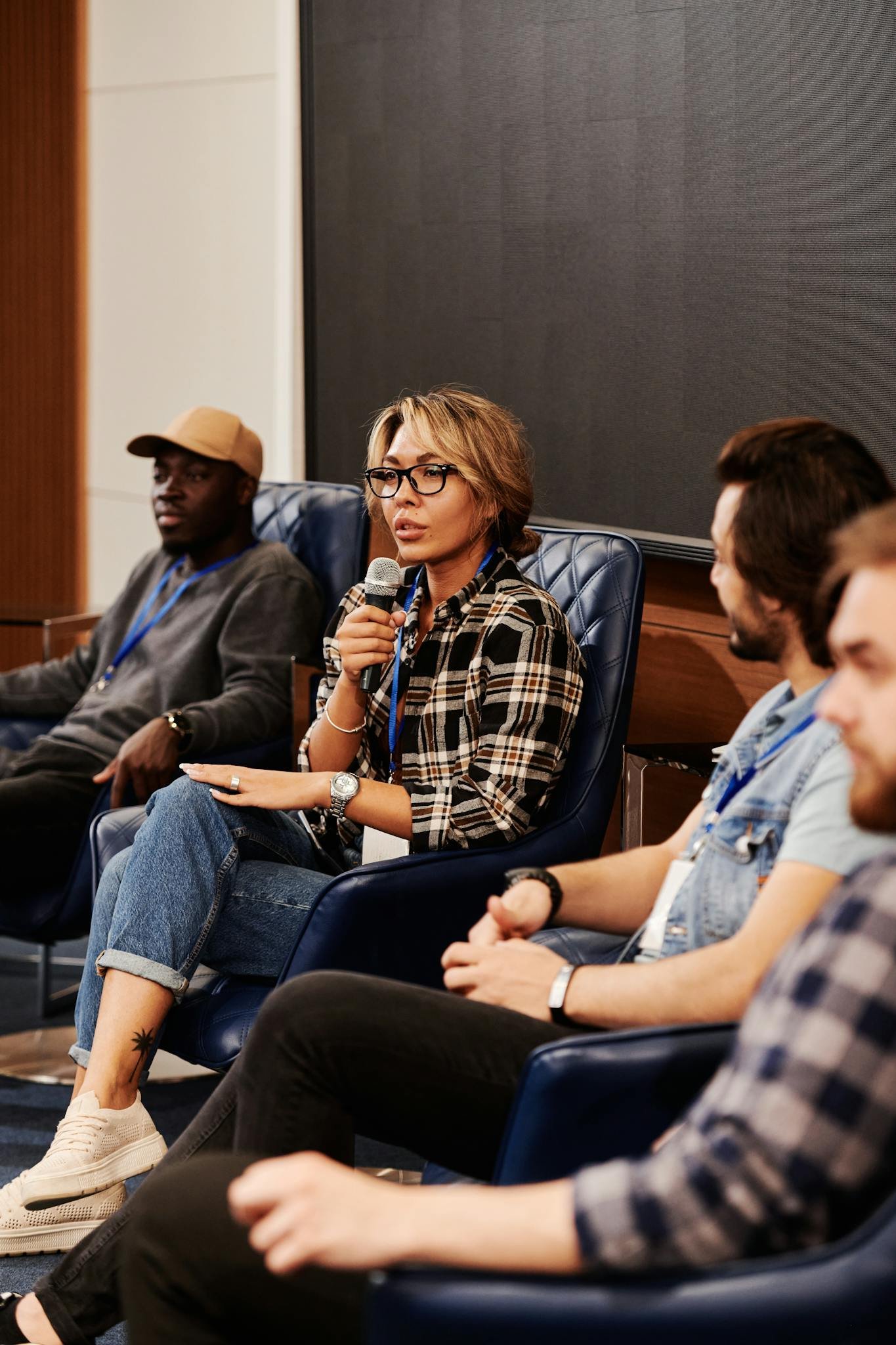 Group of young professionals networking in a modern indoor event.